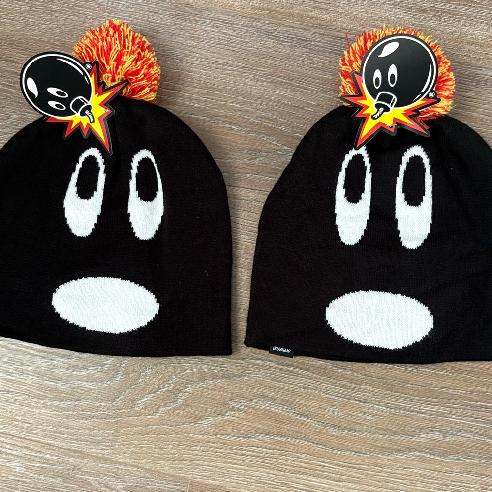 Black and White Beanie with Red and Orange Pom-Pom. Price is for 1 beanie